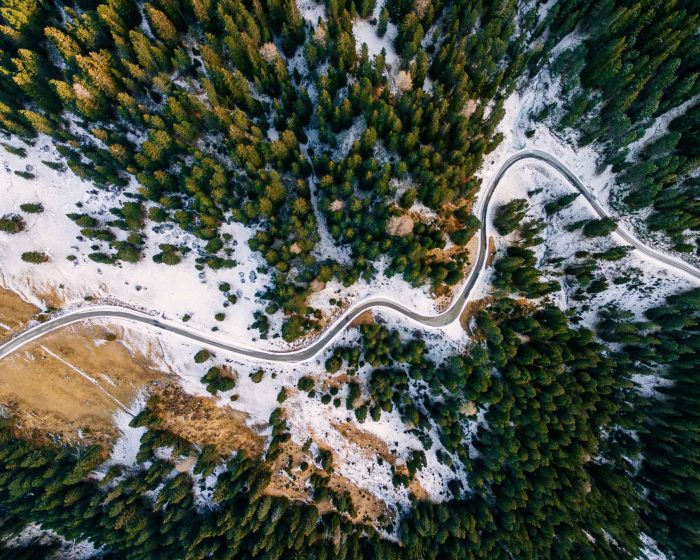aerial-view-of-snowy-forest-with-a-road-captured-f-PAUZRF7.jpg
