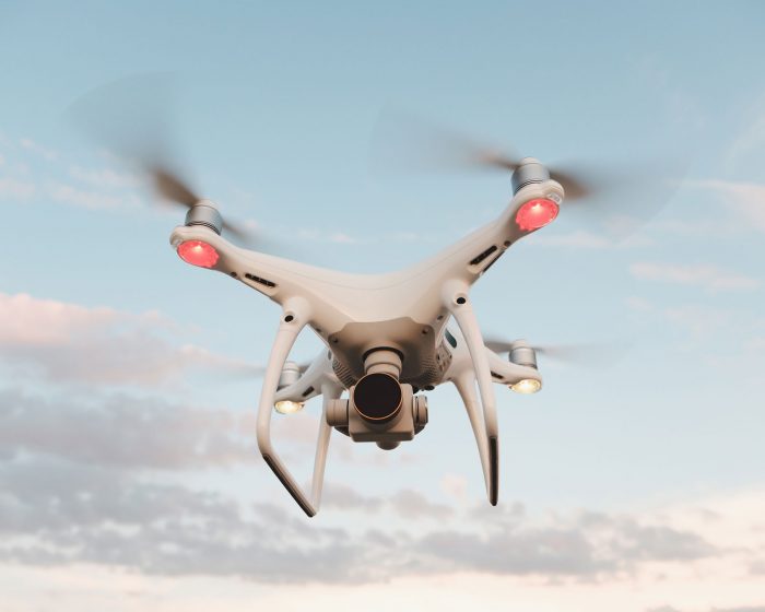 white-drone-hovering-in-a-bright-blue-sky-PMFRLG7.jpg